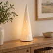 White porcelain Christmas tree lamp by Widdop & Co, decorated with festive details, perfect for holiday decor.