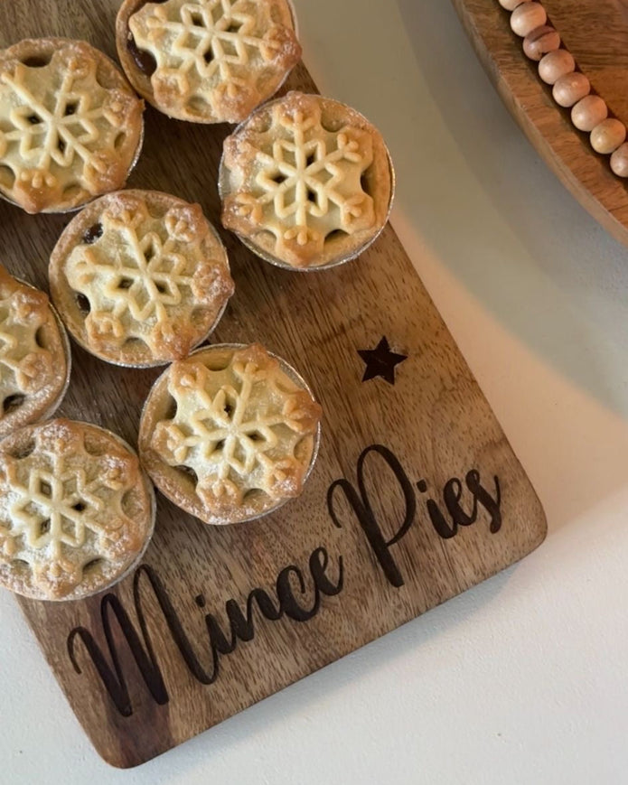 Mince pies on a wooden board with 'Mince Pies' inscription