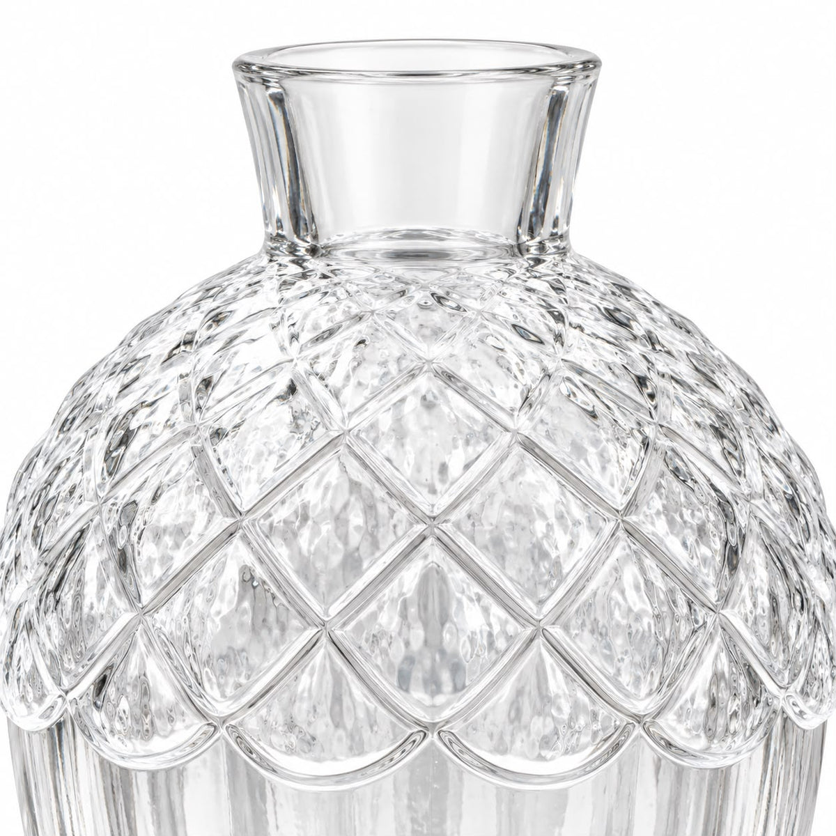 Empty clear glass acorn vase on white