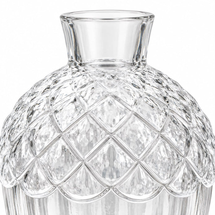 Empty clear glass acorn vase on white