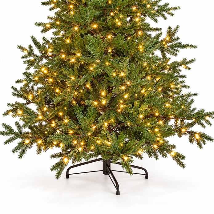 Lower branches, warm lights and black stand of the InLit King Conifer Christmas tree.