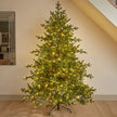 7ft InLit Regal KingTree with green branches and warm lights, standing in a room.