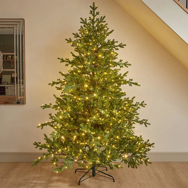 7ft InLit Regal KingTree with green branches and warm lights, standing in a room.
