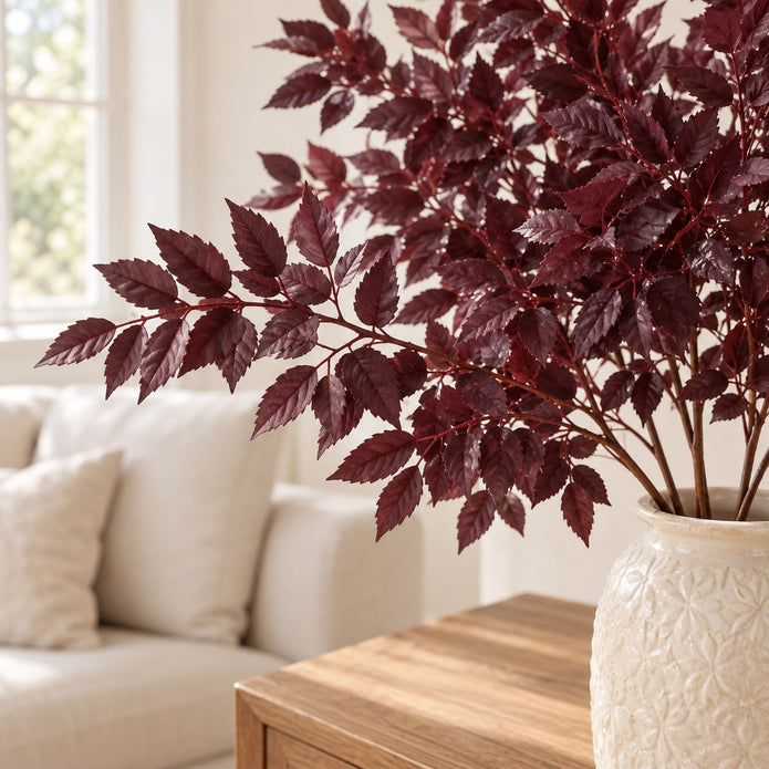 Artificial Burgundy Leaf Foliage Stem, close-up of burgundy foliage in a cream vase