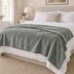 Sage Green Luxury Snuggle Blanket Throw, sage green throw spread across a bed