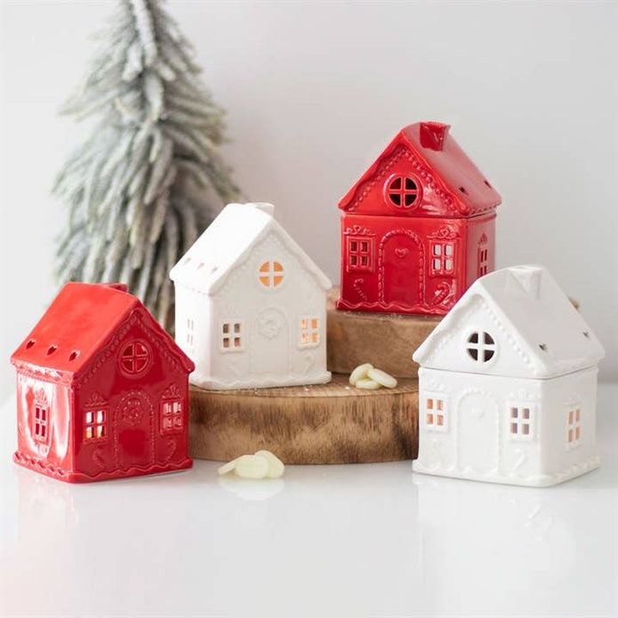 White Christmas gingerbread house tealight candle holder with festive holiday design and detailed gingerbread features.