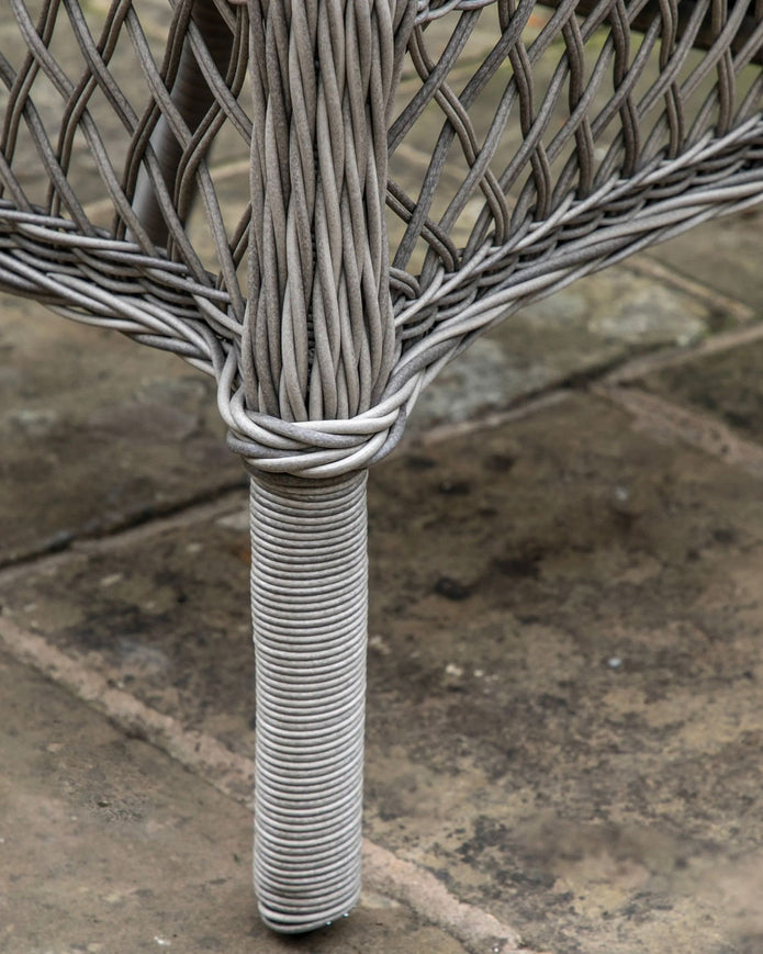 Natural rattan Menton two-seat bistro set by Gallery Direct, featuring woven rattan seats and a round table for garden seating.