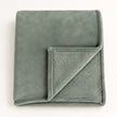 Sage Green Luxury Snuggle Blanket Throw, folded sage green throw with its corner turned back on white