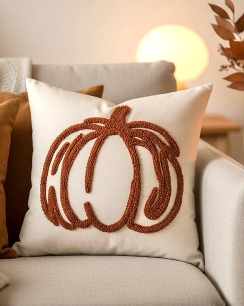 Orange Chenille Pumpkin Cushion Cover, cream cushion with rust pumpkin outline on an armchair