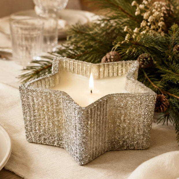 Silver Glass Star Candle - Wild Berries, lit silver star-shaped candle jar on a festive table