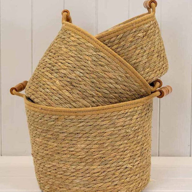 Natural woven rope basket with handles, ideal for home decor storage, by Satchville, showcasing a rustic, handcrafted design.