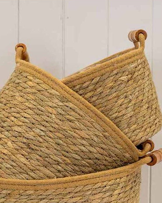 Natural woven rope basket with handles for home decor, featuring a sturdy design and stylish look by Satchville.