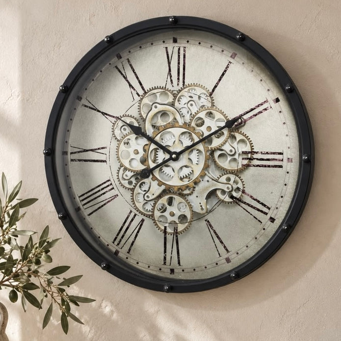 Black frame mechanical skeleton clock with visible gears, branded Heaven Sends, showcasing intricate clockwork design.