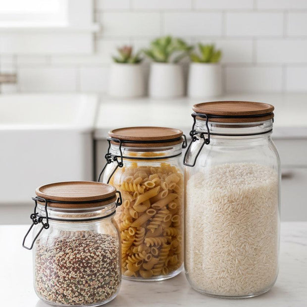 Wooden Lidded Glass Pantry Storage Jar, three clear pantry jars with wooden clip lids holding dry food
