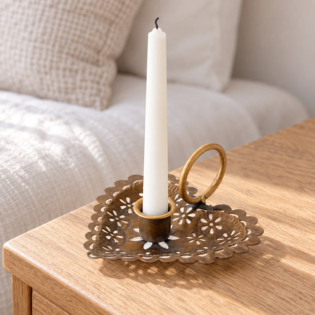 Heart Shaped Metal Candle Holder, heart-shaped holder with an unlit white taper beside a sofa