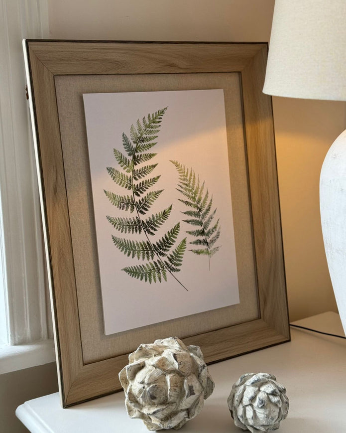 Wooden framed wall art print featuring vibrant green ferns, perfect for nature-inspired home decor by Hill Interiors.