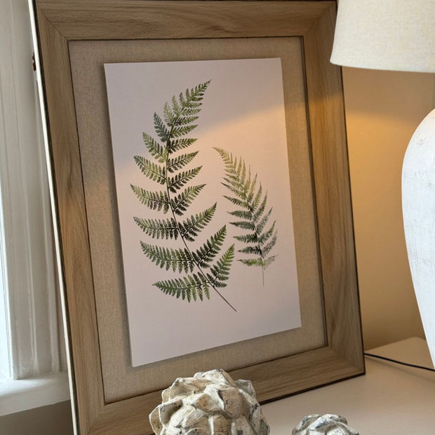 Wooden framed wall art print featuring vibrant green ferns, perfect for nature-inspired home decor by Hill Interiors.