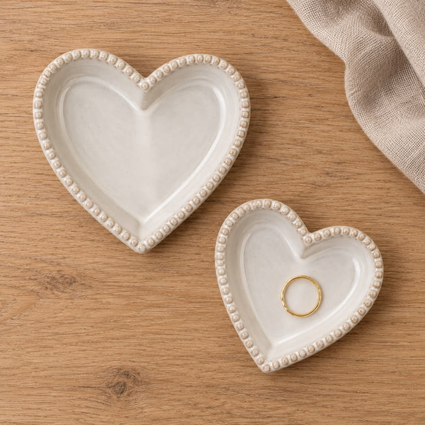 Natural Ceramic Heart Shaped Plate With Bobble Rim, two bobble-rim heart dishes on wood with a ring