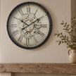 Black Frame Mechanical Skeleton Clock by Heaven Sends showing exposed gears and intricate design on a sleek black frame.
