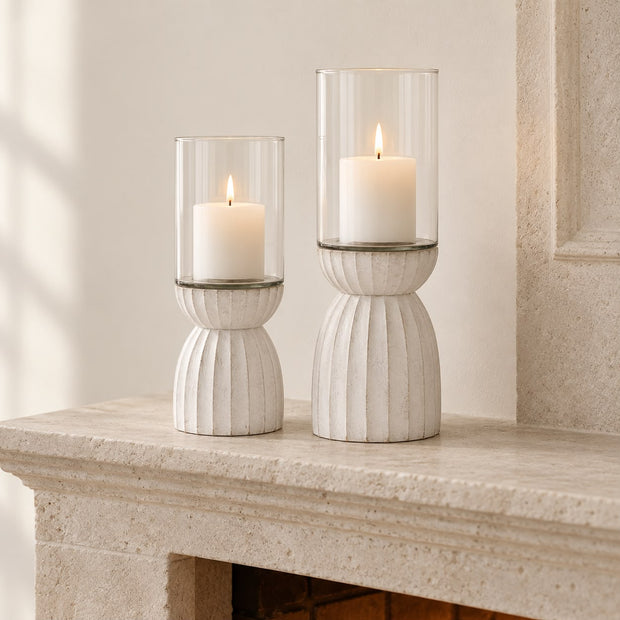 White Carved Hurricane Lantern, two white carved hurricane lanterns with candles on a mantel