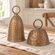 Brass Metal Cloche Cow Bell, two brass cloche bells on a light wooden table