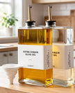 Gold glass dispenser bottles with pourer and label set for kitchen and dining, featuring elegant design and functional accessories.