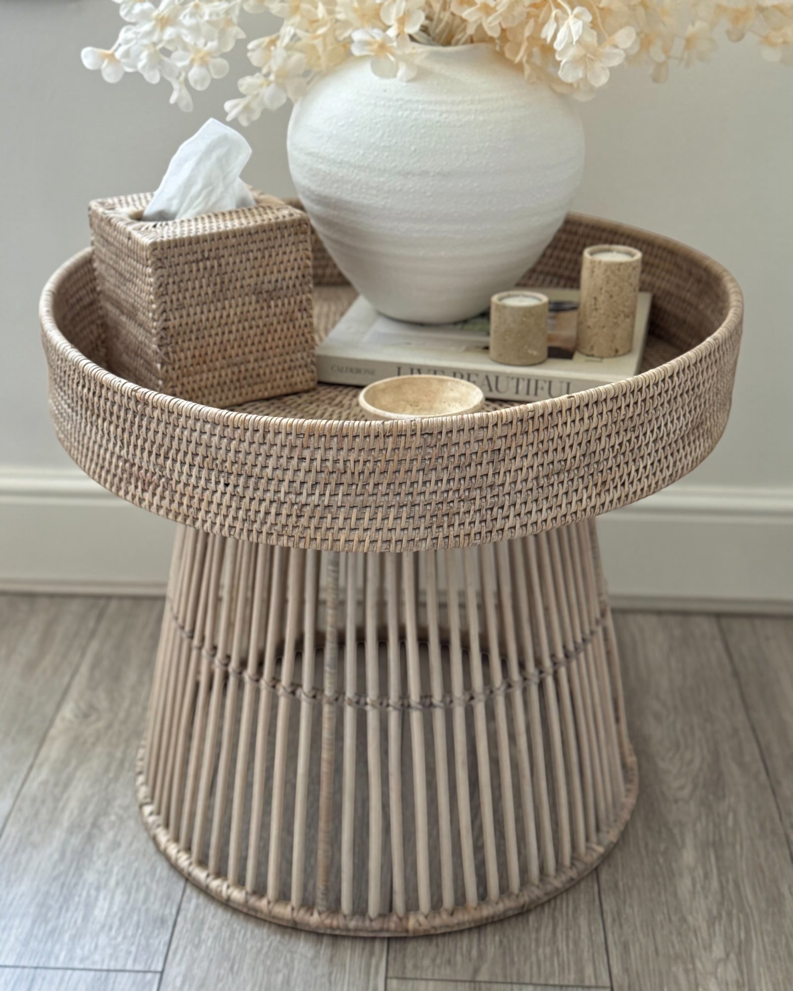 Lows rattan round side table with woven surface, modern furniture piece for living room or patio decor.