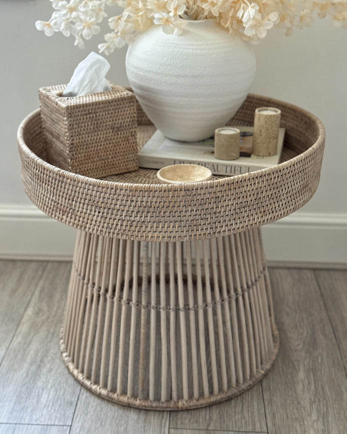 Lows rattan round side table with woven surface, modern furniture piece for living room or patio decor.