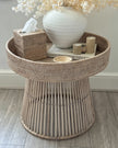 Lows rattan round side table with woven surface, modern furniture piece for living room or patio decor.