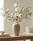 Artificial white and neutral poppy flower stem from Starlight Express, featuring realistic petals and green foliage.
