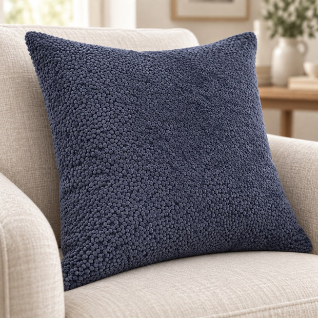 Navy Blue Velvet Bingham Cushion Cover, close-up of the navy textured cushion on a cream seat