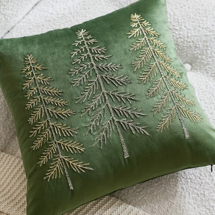 Close-up of the fine tree embroidery and green velvet texture on the Christmas cushion cover.