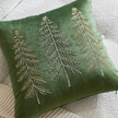 Close-up of the fine tree embroidery and green velvet texture on the Christmas cushion cover.