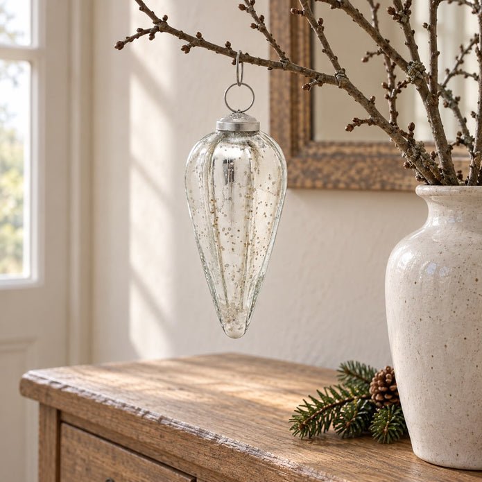 Silver glass Christmas teardrop hanging decoration with a shiny, reflective surface, ideal for festive holiday decor.