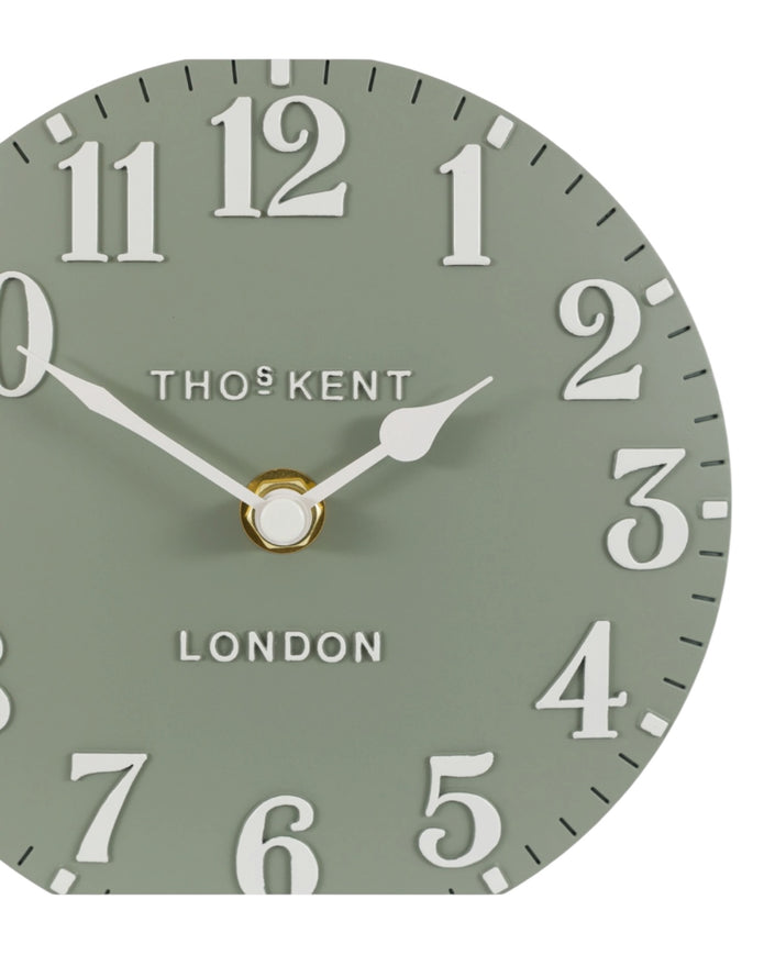 Thomas Kent 6-inch Arabic mantle clock in seagrass green with black numerals and classic round design.