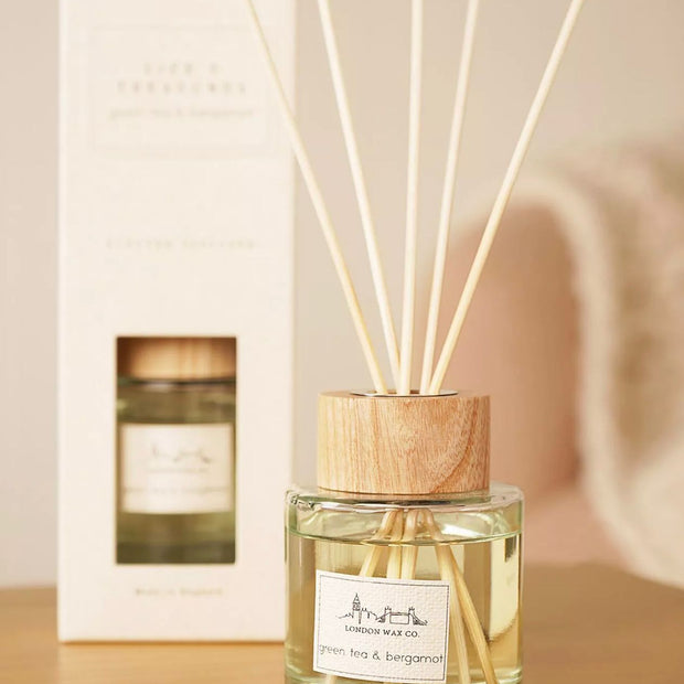 London Wax Company Reed Diffuser - Green Tea and Bergamot, clear reed diffuser with wooden collar beside its white box
