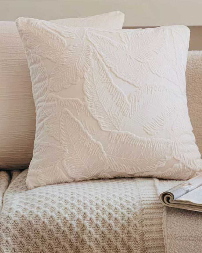Ivory cushion cover with embossed leaf design, soft furnishings by Starlight Express, showcasing textured fabric and elegant decor.