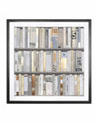 Framed artwork of books with a black frame on a white background