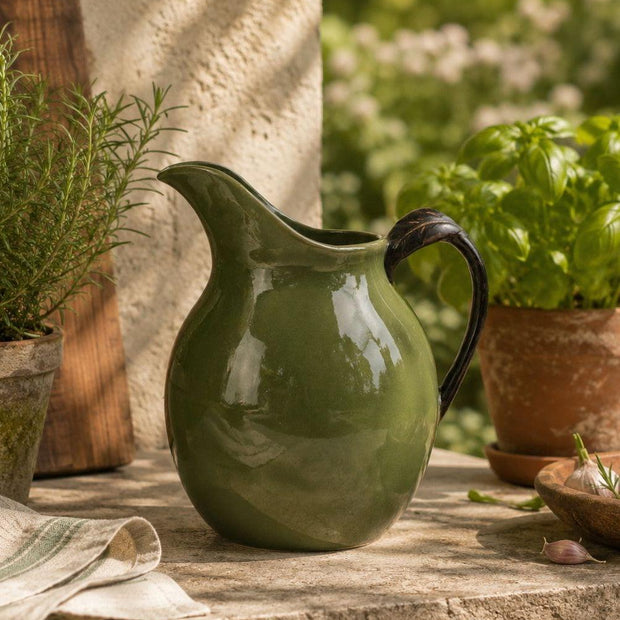 Olive Green Jug Reactive Glaze, olive green glazed jug on a rustic garden table