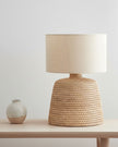 Lows rattan small table lamp with fabric shade for home decor, featuring natural woven rattan design and cozy lighting.