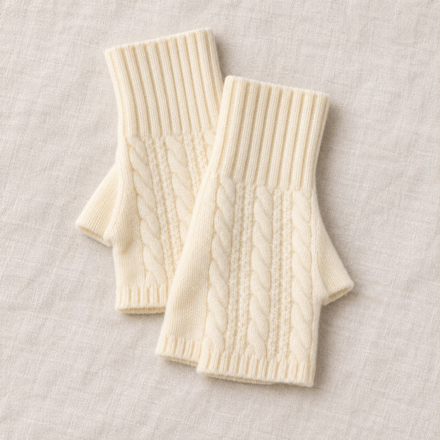 Cream Cosy Cable Knit Fingerless Gloves, overlapping cream cable knit gloves on linen