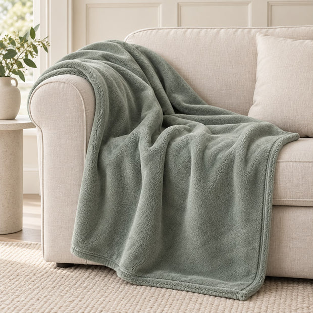 Sage Green Luxury Snuggle Blanket Throw, sage green throw draped over a cream sofa