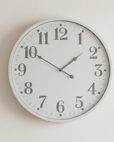 White round Aubrey wall clock by Hill Interiors showing a sleek, minimalist design with black hour and minute hands.