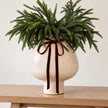 Gallery Direct Palawan neutral white stoneware footed vase with a rounded shape and textured surface.