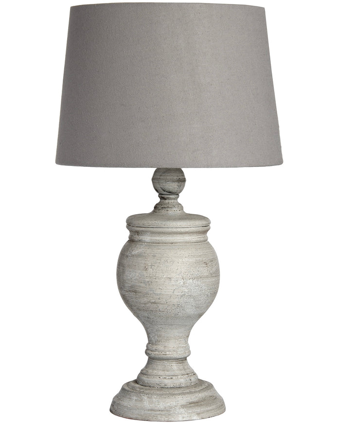 Uthina wooden table lamp by Hill Interiors featuring a sleek, natural wood finish and modern lighting design on a table surface.