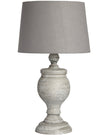 Uthina wooden table lamp by Hill Interiors featuring a sleek, natural wood finish and modern lighting design on a table surface.