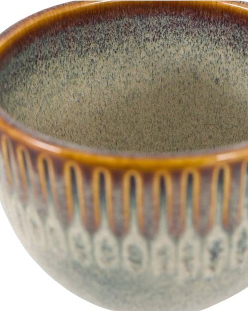 Ceramic bowl with brown and green speckled design on a white background