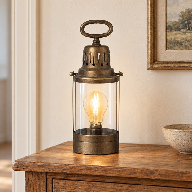 Rustic Metal Lantern, antique-finish lantern lamp on a wooden console