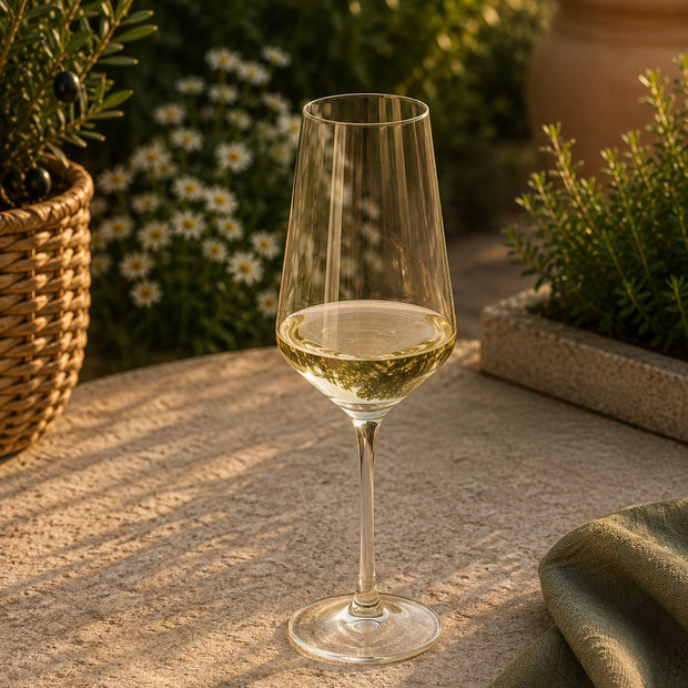 Smokey Green Single Champagne Flute Glass, slim champagne glass holding a drink on a garden table
