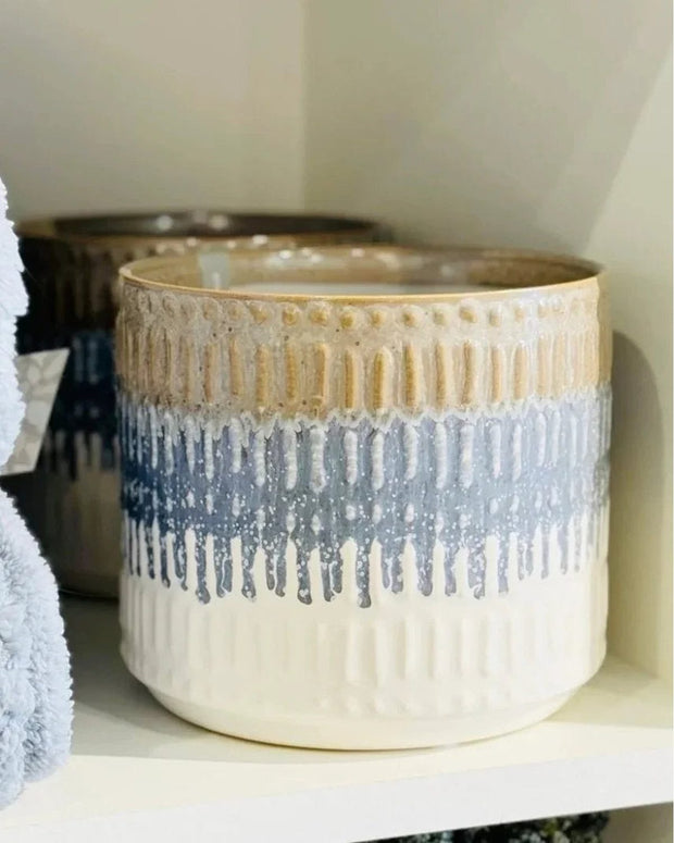 Ceramic planter with textured design on a shelf